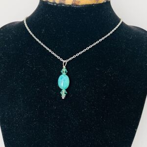 Oval turquoise & crystals pendant set in silver plus a stainless steel necklace